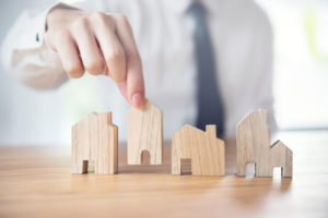 Hand of businessman choosing house model, Planning buy Real Estate