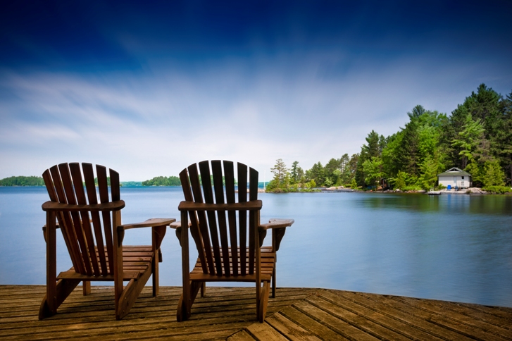 wooden deck chair facing the beautiful view of the lake